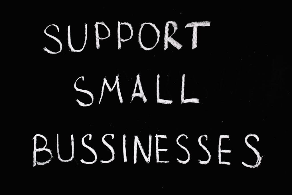 Inspirational chalkboard text 'Support Small Businesses' on black background.